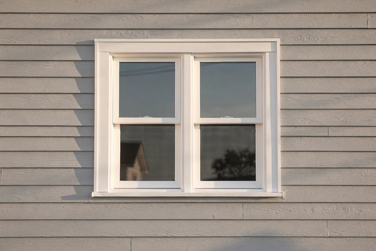 Brand-new white double-hung window with fresh trim